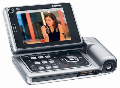 Nokia N92, reproductor de MP3 y AAC, auriculares, radio FM, Visual Radio, radio con imágenes, cámara VGA, DVB-H, videocall, ver y grabar televisión en celular, cámara digital con flash de 2 megapíxeles, Tom Cruise con el Nokia N92 en Mission Imposible 3